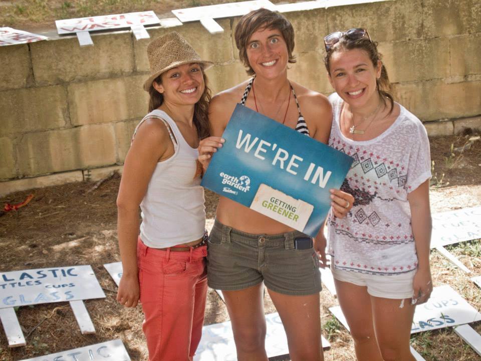 Greta, Gayle and Michela holding the We're In sign pre-Earth Garden.